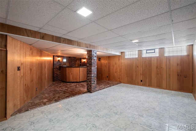 7849 Cassia Ct, Saint Louis, MO 63123 - below grade area featuring wooden walls, bar area, and a drop ceiling