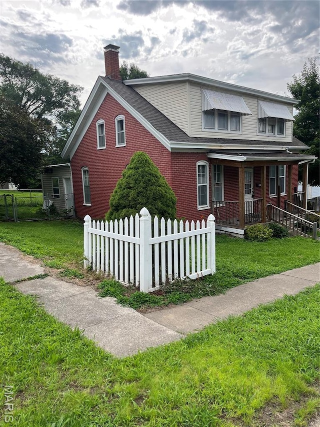 121 N 13th St, Louisiana, MO 63353 - view of front facade with a porch, a chimney, and brick siding