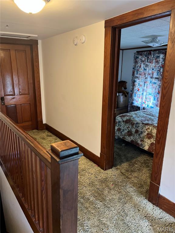 121 N 13th St, Louisiana, MO 63353 - hallway featuring carpet and an upstairs landing
