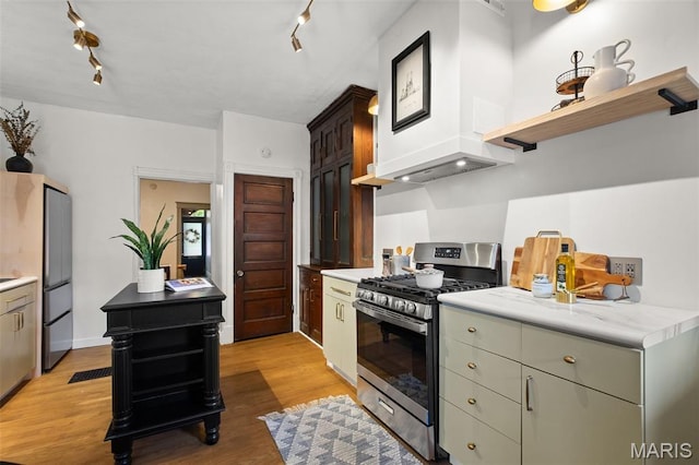 2929 Victor St, Saint Louis, MO 63104 - kitchen with stainless steel range with gas stovetop, open shelves, light wood-type flooring, light countertops, and track lighting