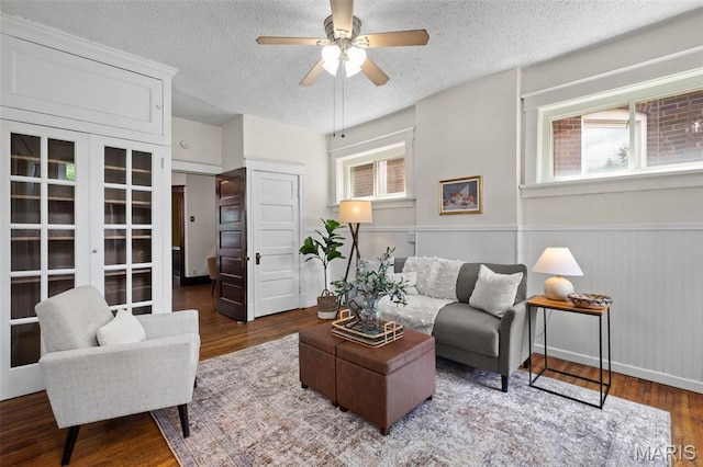 2929 Victor St, Saint Louis, MO 63104 - living room featuring a textured ceiling, plenty of natural light, wood finished floors, a wainscoted wall, and ceiling fan