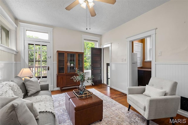 2929 Victor St, Saint Louis, MO 63104 - living room featuring wainscoting, a textured ceiling, wood finished floors, and a ceiling fan