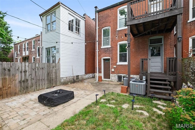 2929 Victor St, Saint Louis, MO 63104 - rear view of property featuring a balcony, brick siding, and a patio
