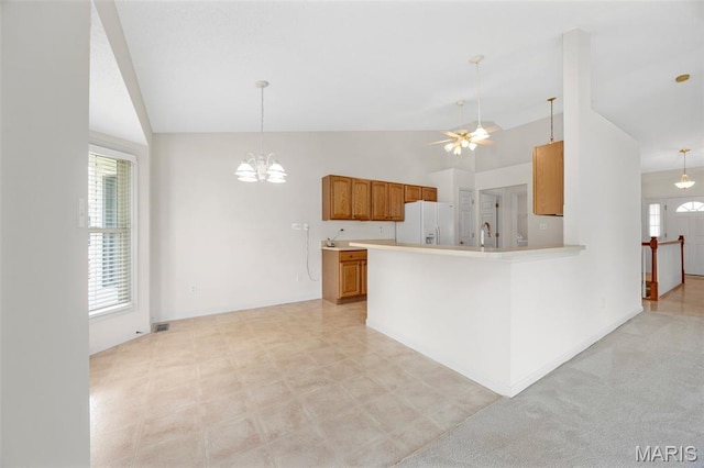 2749 Samuel Dr Unit 736A, Dardenne Prairie, MO 63368 - kitchen featuring lofted ceiling, brown cabinets, white fridge with ice dispenser, light countertops, and a chandelier