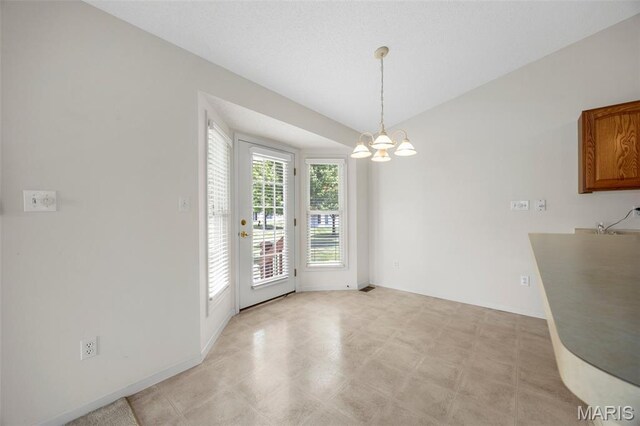 2749 Samuel Dr Unit 736A, Dardenne Prairie, MO 63368 - unfurnished dining area featuring a chandelier and baseboards