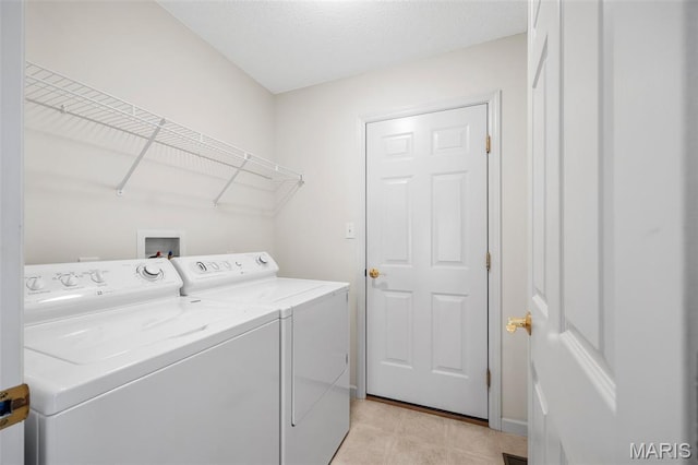 2749 Samuel Dr Unit 736A, Dardenne Prairie, MO 63368 - washroom featuring washing machine and clothes dryer and light tile patterned floors