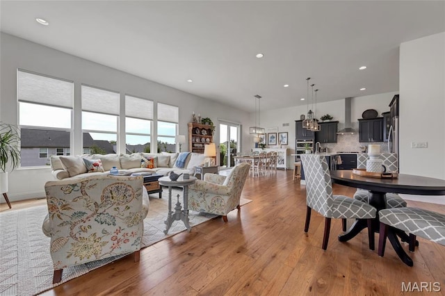 2308 Sand Cherry Dr, Wildwood, MO 63011 - living room featuring light wood finished floors, recessed lighting, and a chandelier