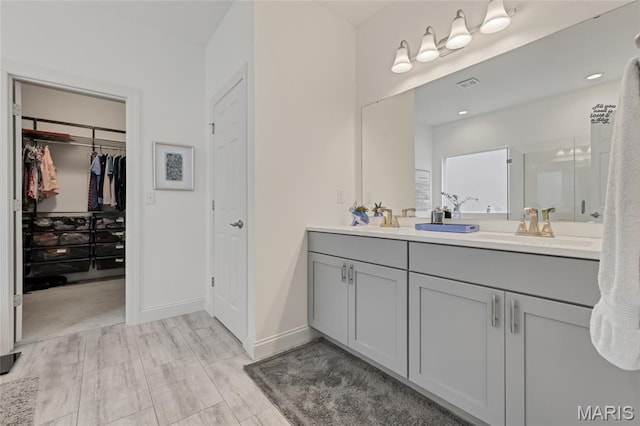 2308 Sand Cherry Dr, Wildwood, MO 63011 - full bath with double vanity, a walk in closet, an enclosed shower, and recessed lighting