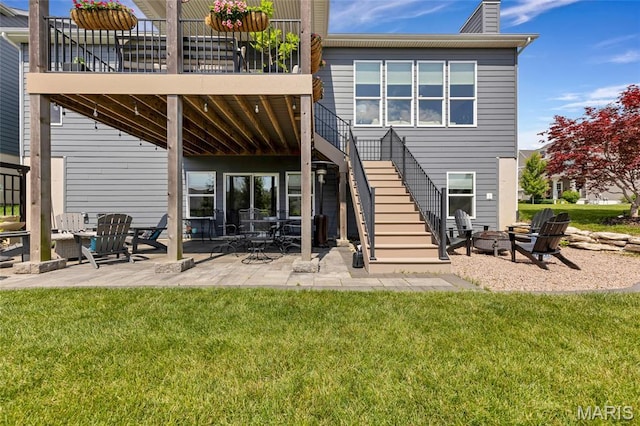 2308 Sand Cherry Dr, Wildwood, MO 63011 - rear view of house with stairway, a fire pit, a patio, a yard, and a chimney