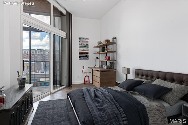 4570 Laclede Ave Unit 301, Saint Louis, MO 63108 - bedroom with access to exterior and wood finished floors