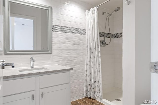 4570 Laclede Ave Unit 301, Saint Louis, MO 63108 - full bath featuring tile walls, vanity, a shower stall, and wood finished floors