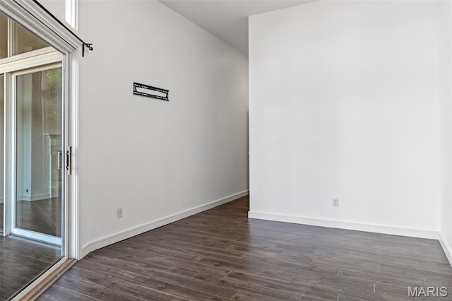 4570 Laclede Ave Unit 301, Saint Louis, MO 63108 - unfurnished room with dark wood-style flooring and baseboards