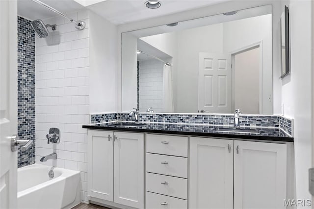 4570 Laclede Ave Unit 301, Saint Louis, MO 63108 - bathroom with shower / tub combo, double vanity, and tasteful backsplash