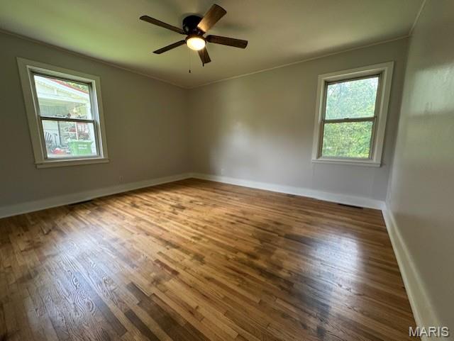 618 Houston Rd, Rolla, MO 65401 - empty room featuring wood finished floors, crown molding, and ceiling fan