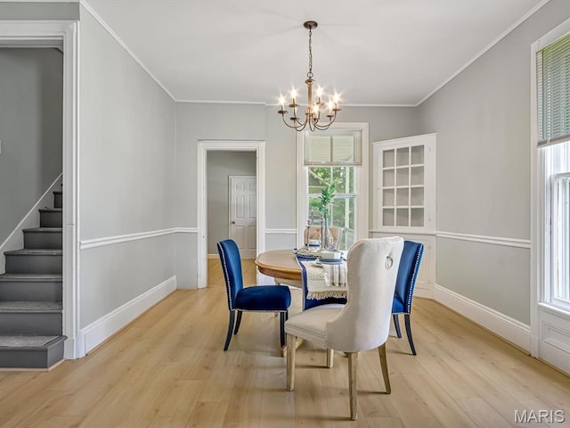 1734 Seminary St, Alton, IL 62002 - dining space with a chandelier, light wood-style floors, stairway, and ornamental molding