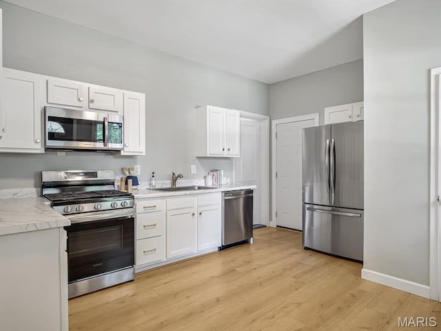 1734 Seminary St, Alton, IL 62002 - kitchen with stainless steel appliances, light wood finished floors, white cabinets, and light countertops
