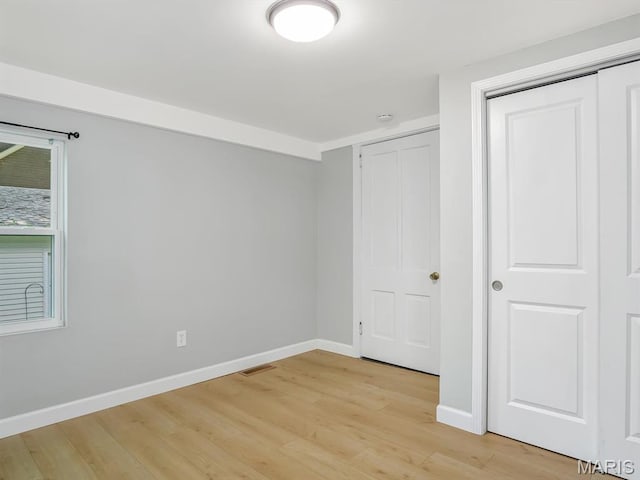 1734 Seminary St, Alton, IL 62002 - unfurnished bedroom with light wood finished floors and a closet
