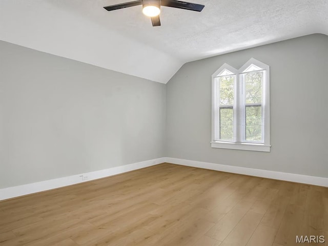 1734 Seminary St, Alton, IL 62002 - additional living space featuring vaulted ceiling, light wood-style floors, ceiling fan, and a textured ceiling