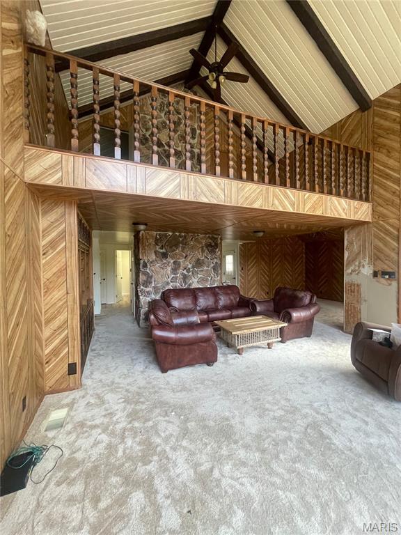 252 Trails End Way, Doniphan, MO 63935 - carpeted living room with wooden walls, high vaulted ceiling, a ceiling fan, and beamed ceiling