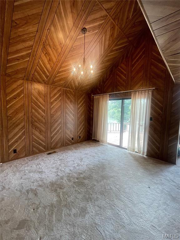 252 Trails End Way, Doniphan, MO 63935 - unfurnished living room with a chandelier, wooden walls, carpet flooring, vaulted ceiling, and wood ceiling