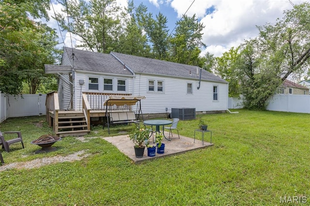 39 Pine St, Farmington, MO 63640 - rear view of house with a fire pit, a wooden deck, a patio area, a fenced backyard, and roof with shingles