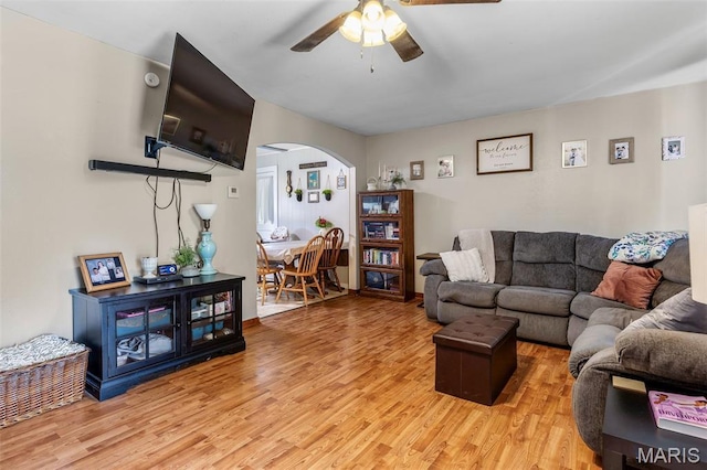 39 Pine St, Farmington, MO 63640 - living room with arched walkways, ceiling fan, and light wood-type flooring