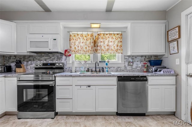 39 Pine St, Farmington, MO 63640 - kitchen with appliances with stainless steel finishes, white cabinets, decorative backsplash, and light stone counters