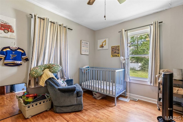 39 Pine St, Farmington, MO 63640 - bedroom with a nursery area, wood finished floors, and a ceiling fan