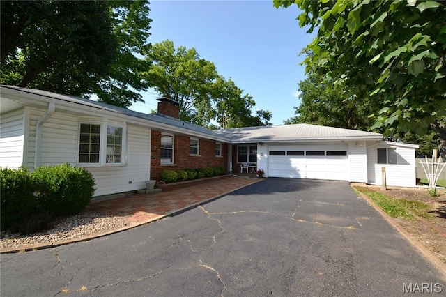 1406 Marshall Rd, Kirkwood, MO 63122 - ranch-style house featuring asphalt driveway, a garage, and a chimney