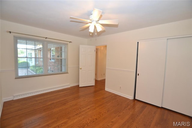 1406 Marshall Rd, Kirkwood, MO 63122 - unfurnished bedroom featuring a baseboard radiator, a closet, wood finished floors, and ceiling fan