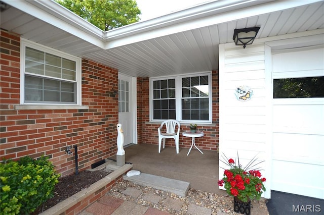 1406 Marshall Rd, Kirkwood, MO 63122 - view of exterior entry featuring a porch and brick siding