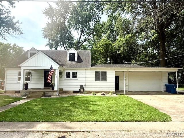 902 Sycamore St, Germantown, IL 62245 - view of front of house featuring covered porch, driveway, a garage, and a front lawn