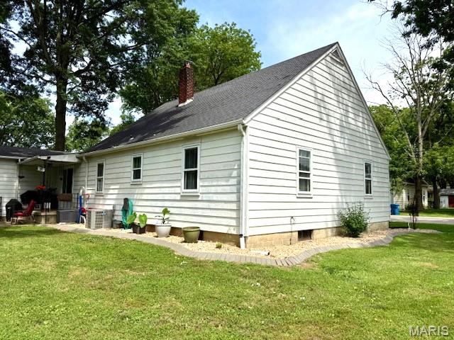 902 Sycamore St, Germantown, IL 62245 - view of property exterior featuring a chimney and a yard