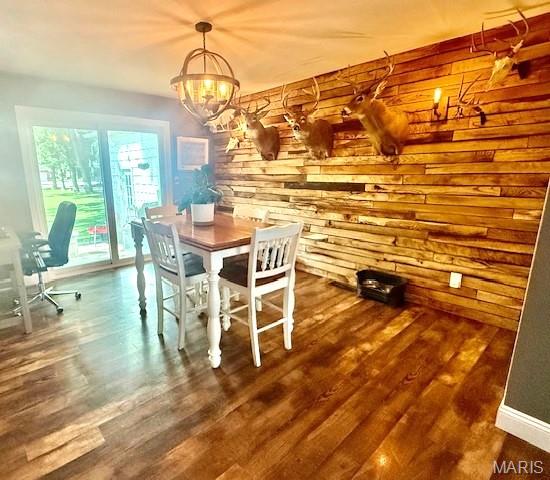 902 Sycamore St, Germantown, IL 62245 - dining space featuring wood finished floors, a chandelier, wood walls, and an office area