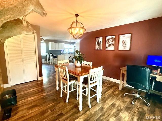 902 Sycamore St, Germantown, IL 62245 - dining area featuring dark wood-style floors, a chandelier, and an office area