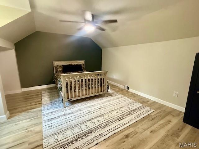 902 Sycamore St, Germantown, IL 62245 - bedroom with wood finished floors, lofted ceiling, and a ceiling fan