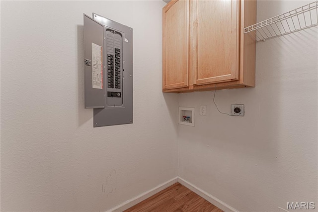 1221 Napoleon Dr, Bonne Terre, MO 63628 - laundry room featuring electric panel, cabinet space, washer hookup, wood finished floors, and electric dryer hookup