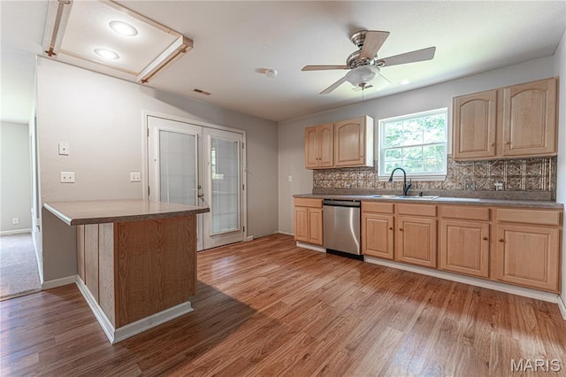 1221 Napoleon Dr, Bonne Terre, MO 63628 - kitchen with stainless steel dishwasher, light brown cabinetry, light wood-type flooring, and backsplash