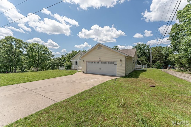 1221 Napoleon Dr, Bonne Terre, MO 63628 - view of side of property with a lawn, concrete driveway, and an attached garage