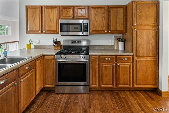 227 W Woodland Rdg, Valmeyer, IL 62295 - kitchen with stainless steel appliances, brown cabinetry, and dark wood finished floors
