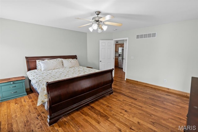 227 W Woodland Rdg, Valmeyer, IL 62295 - bedroom with stainless steel refrigerator with ice dispenser, wood finished floors, and ceiling fan