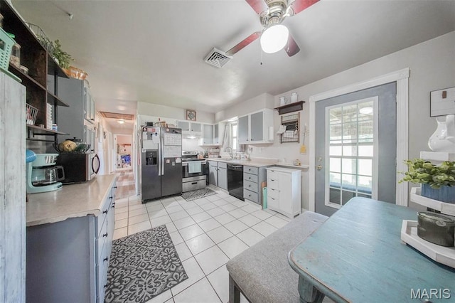 532 Christine St, St James, MO 65559 - kitchen with appliances with stainless steel finishes, light tile patterned flooring, open shelves, ceiling fan, and light countertops