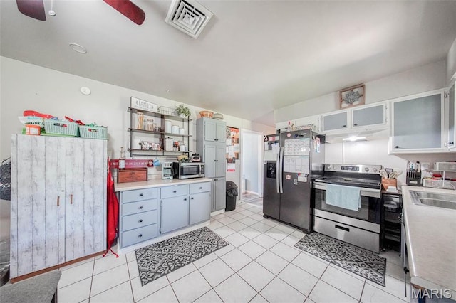 532 Christine St, St James, MO 65559 - kitchen with stainless steel appliances, light countertops, under cabinet range hood, and light tile patterned flooring