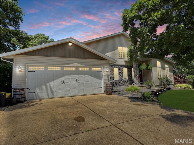 360 David Dr, Washington, MO 63090 - view of front facade featuring stone siding, concrete driveway, and an attached garage