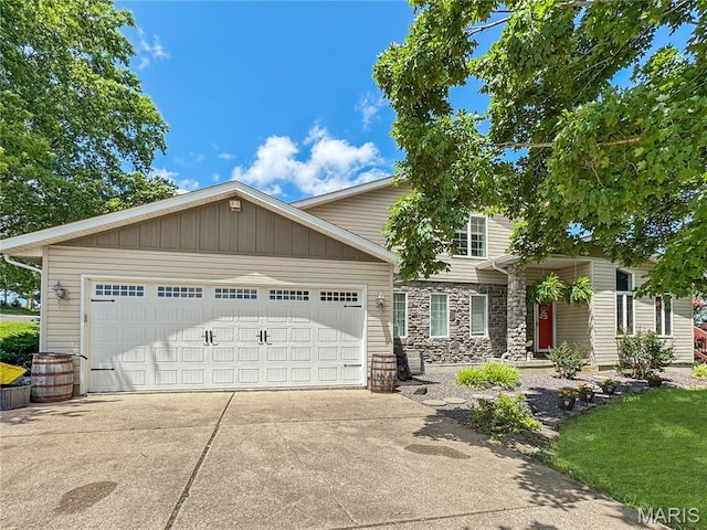 360 David Dr, Washington, MO 63090 - view of front of house featuring stone siding, driveway, and a garage