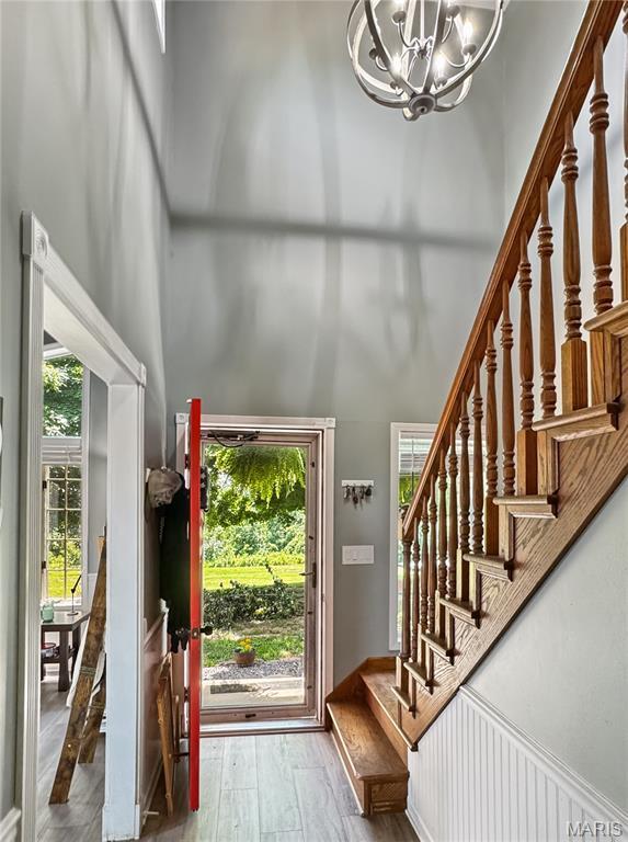 360 David Dr, Washington, MO 63090 - foyer entrance with a high ceiling, a chandelier, healthy amount of natural light, stairs, and wood finished floors
