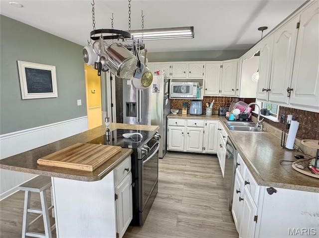 360 David Dr, Washington, MO 63090 - kitchen with stainless steel appliances, white cabinets, dark countertops, and tasteful backsplash