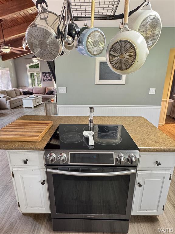 360 David Dr, Washington, MO 63090 - kitchen featuring electric range, light wood-style floors, white cabinetry, and a wooden ceiling with exposed beams