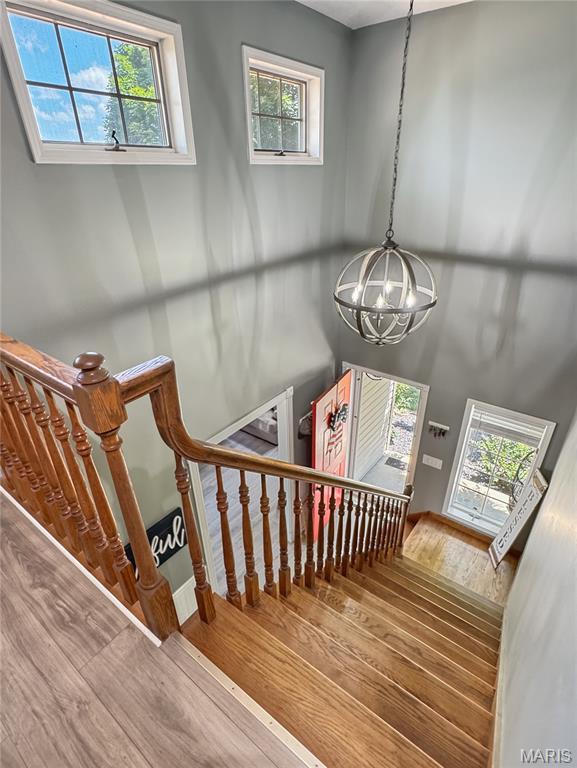 360 David Dr, Washington, MO 63090 - staircase with a chandelier, wood finished floors, and healthy amount of natural light