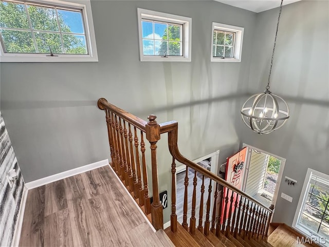 360 David Dr, Washington, MO 63090 - stairway featuring a chandelier, wood finished floors, and healthy amount of natural light